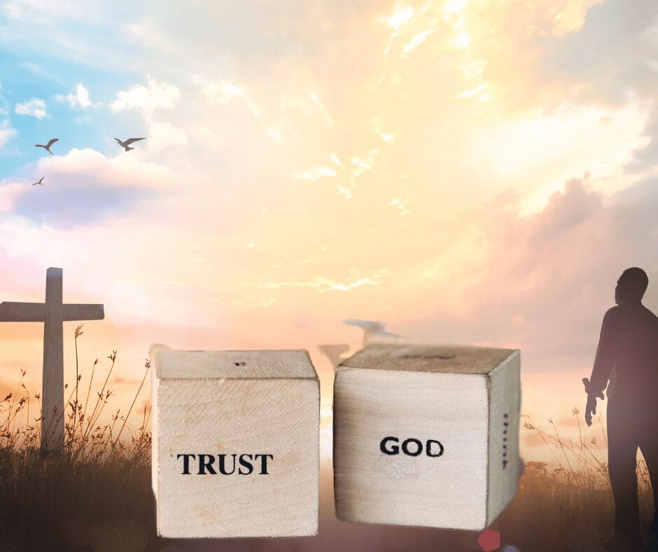 Inspirational sunset with cross, "TRUST GOD" text, and silhouette.